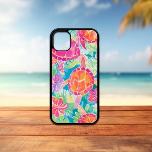 May include: A black phone case with a colorful design of sea turtles and flowers. The design features pink, orange, yellow, blue, and green colors.