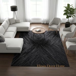 May include: A modern living room featuring a large white sectional sofa, gray armchairs, and a round coffee table. A dark gray patterned rug dominates the center of the room. The text "Elyssia Decor Home" is visible on the rug.