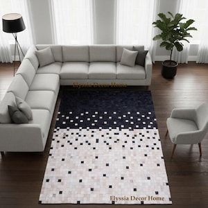 May include: A rectangular area rug featuring a pixelated gradient pattern that transitions from solid black at the top to a light cream and white color at the bottom, composed of small square tiles with the text Elysia Decor Home visible.