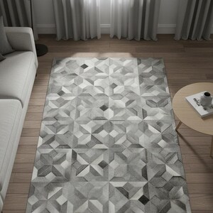 Könnte beinhalten: Rechteckiger Teppich mit geometrischem Muster in Grautönen. Das Design besteht aus sich wiederholenden Winkeln. Der Teppich scheint aus einem weichen Material zu sein. Der Text "Elyssia Decor Home" ist auf dem Teppich zu sehen. Geeignet für Wohnzimmer.