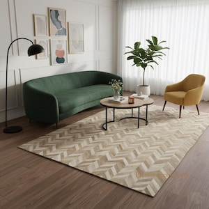 May include: A living room scene featuring a green sofa, a yellow armchair, and a round coffee table. The room has a light-colored, patterned rug and a floor lamp. Artwork hangs on the wall, and a plant sits near the window.