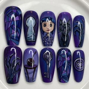 May include: A set of ten press-on nails featuring a purple color palette with hand-painted designs including a stained glass pattern, a keyhole, a character with button eyes, a black cat, skeletal hands, a table with a key, and a large button.