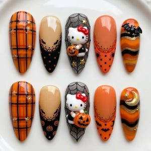 May include: A set of ten almond-shaped press-on nails featuring Halloween themes. Designs include orange and black plaid with gold stars, beige and black lace patterns with pumpkins and bats, and a 3D Hello Kitty figure holding a pumpkin.