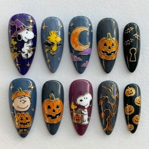 May include: A set of ten almond-shaped press-on nails featuring Halloween themes. Designs include Snoopy in a witch hat, Woodstock as a bat, a crescent moon, jack-o'-lanterns, a keyhole, Charlie Brown in a pumpkin costume, and a bare tree.