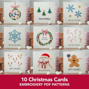 May include: A collection of nine square greeting cards featuring embroidered holiday designs including a Christmas ornament, pine trees, snowflakes, a wreath, candy canes, reindeer antlers, Santa Claus, and a gingerbread man with text.