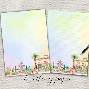 May include: Two sheets of writing paper with a watercolor design. One sheet is blank, the other has lines. The bottom border features a colorful illustration of a fountain, cacti, and market stalls. A black pen rests on the lined sheet. The words "Writing paper" are written at the bottom.