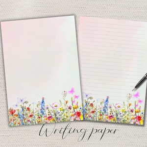 Può includere: Due fogli di carta da scrivere con un bordo floreale di fiori selvatici e farfalle. Un foglio è bianco, l'altro a righe. Una penna nera poggia sul foglio a righe. Le parole "Writing paper" sono scritte in basso.