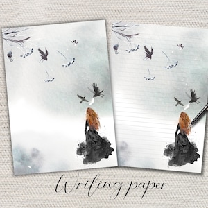 Puede incluir: Dos hojas de papel de escritura con una ilustración de acuarela. Una hoja está en blanco, la otra rayada. La obra de arte presenta a una mujer con cabello rojo, vestido negro y cuervos volando sobre un fondo brumoso. Las palabras "Writing paper" están en la parte inferior.