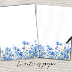 Peut inclure: Deux feuilles de papier à écrire blanches avec un motif floral. Le bas de chaque feuille présente une illustration à l'aquarelle de fleurs bleues et de feuillage vert. Une feuille est lignée, l'autre est vierge. Un stylo noir repose sur la feuille lignée. Le mot "Writing paper" est écrit en bas.