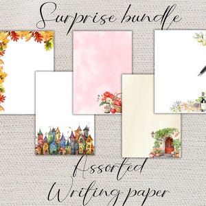 May include: A collection of assorted writing paper sheets with watercolor designs. The sheets feature various themes, including autumn leaves, pink watercolor, a basket of flowers, a pen, a wine bottle, and a village. The words "Surprise bundle" and "Assorted Writing paper" are written in cursive.
