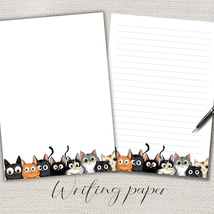 May include: Two sheets of white writing paper, one blank and one lined, with a border of cartoon cats. The cats are in various colours. A black pen rests on the lined paper. The words "Writing paper" are at the bottom.
