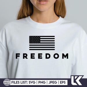 May include: White sweatshirt with a black American flag graphic and the word "FREEDOM" printed below. The design features a black and white flag with stars and stripes.