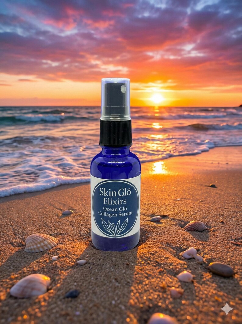 May include: A blue glass spray bottle of Skin Glo Elixirs Ocean Glo Collagen Serum on a sandy beach with seashells. The background features an ocean and a sunset with orange and yellow hues.