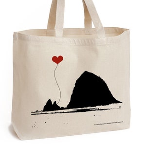 May include: A white canvas tote bag with a black silhouette of Haystack Rock and a red heart balloon. The text "© smith/Samantha Ramsey. All Rights Reserved." is printed on the bottom of the bag.