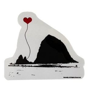 May include: A black and white silhouette of Haystack Rock, a famous landmark in Oregon, with a red heart-shaped balloon floating above it. The rock is on a beach with a small group of people in the distance. The text "Goodlife. All Rights Reserved." is at the bottom of the image.