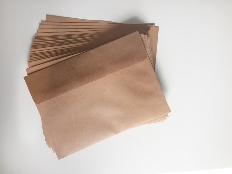 May include: A stack of brown paper envelopes. The top envelope is folded over to reveal the inside.
