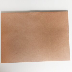 May include: A plain brown sheet of paper.