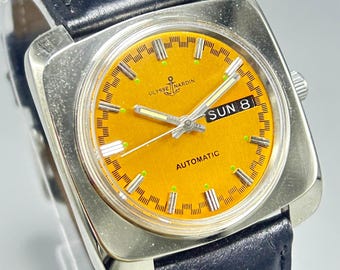 Relógio de pulso masculino raro vintage ULYSSE NARDIN com 21 joias, mostrador laranja, automático, dia e data, movimento suíço, parte traseira transparente