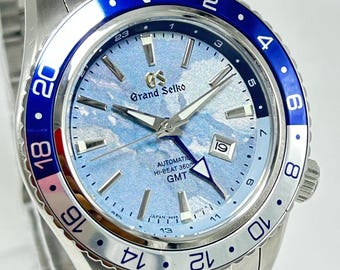Reloj de pulsera Grand Seiko GMT automático reacondicionado con indicador de fecha, esfera azul, bisel giratorio y correa de acero inoxidable para hombre.