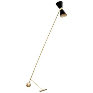 May include: A mid-century modern floor lamp with a black and gold finish. The lamp features a slender, gold-toned pole with a black, cone-shaped shade. The base has a gold sphere and a rectangular foot. The lamp is approximately 152 cm tall.