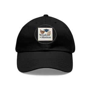 May include: Black baseball cap with a curved brim. A circular patch on the front features a mortar and pestle, a graduation cap, and pill bottles, with the text "Wisdom in Motion" in a white box.