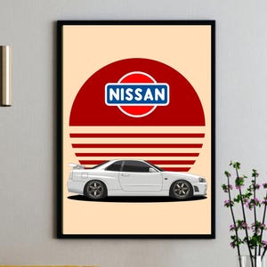 May include: White Nissan sports car art print. The print features a white car with black wheels, set against a red and white background with the Nissan logo. The artwork is framed in a black frame.
