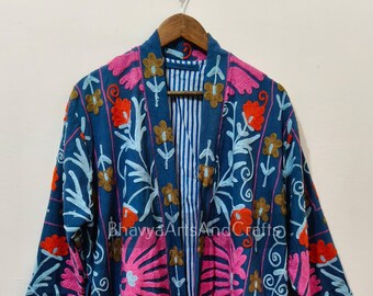 May include: A blue embroidered kimono-style robe with a floral design in pink, orange, and light blue. The robe has a striped interior and a matching belt. The text "BhavyaArts And Craft" is visible on the robe.