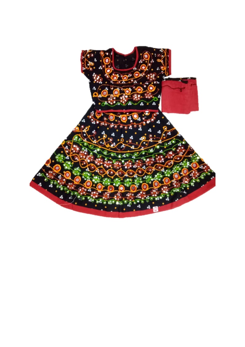 May include: Black dress with intricate embroidery in orange, green, and white. The dress features a red trim and a matching red accessory. The design includes floral and geometric patterns, creating a vibrant and detailed look. The dress is likely a traditional garment.