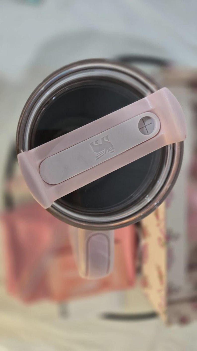 May include: A white ceramic mug with a black handle and the text "But First, Coffee" in a black, bold font. The mug is sitting on a wooden surface. The mug is 4 inches tall.