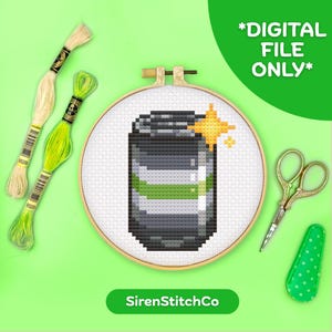 May include: A cross-stitch pattern of a soda can in a wooden hoop, with green and white embroidery floss, gold scissors, and a green needle minder. The text "*DIGITAL FILE ONLY*" is in the upper right corner, and "SirenStitchCo" is at the bottom.