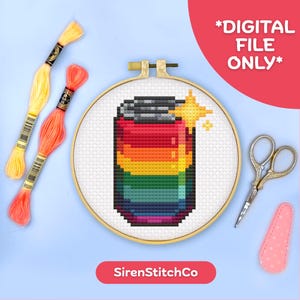 May include: A cross-stitch design of a rainbow-colored soda can in a wooden embroidery hoop. The image includes yellow and orange embroidery floss, gold scissors, and a pink needle minder. Text on the image reads "*DIGITAL FILE ONLY*" and "SirenStitchCo".