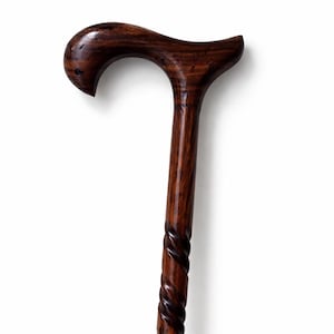 May include: A dark brown wooden cane with a curved handle and a spiral design on the lower portion. The cane is made of polished wood, showcasing the natural grain and texture. The handle is smooth and ergonomic.