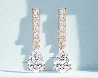 Pear-Cut Drop with accenting Round Diamonds. Available in 10K, 14K, 18k Gold & 925 Sterling Silver, Also in Lab-Grown or Moissanite Diamond