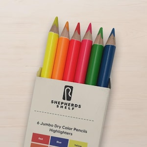 May include: A box of six jumbo dry color pencils in a variety of bright colors, including yellow, orange, red, pink, green, and blue. The pencils are labeled as highlighters and are from Shepherds Shelf.