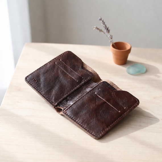 A slim bifold wallet hand-cut from full veg-tanned cowhide and custom engraved — the kind of everyday carry piece that ages beautifully and gets better with use.