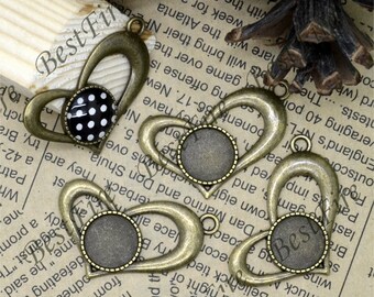 May include: Three antique gold-toned metal heart-shaped pendants with a round glass bezel. The pendants are perfect for adding a vintage touch to jewelry making projects.