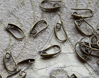 May include: A group of antique gold-toned earring hooks. The hooks are made of metal and have a simple, elegant design.