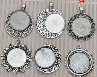 May include: Six silver-toned pendant trays with different designs. The trays are round and have a smooth, shiny surface. They are perfect for creating custom jewelry.