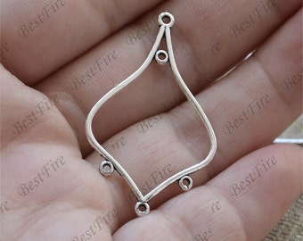 May include: Silver-toned metal pendant with a diamond-shaped frame and five small round holes. The pendant is designed to be used for jewelry making.
