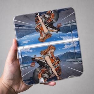 May include: A foldable handheld gaming console case featuring a mirrored anime-style illustration of a character with long orange hair riding an orange and black sport motorcycle on a highway. The text Langley and Asuka are printed on the motorcycle.