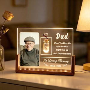 May include: A lighted memorial plaque with a photo of a man, a decorative jar, and the word "Dad." Text reads "When You Miss Me, Have No Fear, Light This Up, And Know I'm Here" and "In Loving Memory 1959-2026."