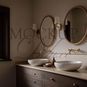 May include: A bathroom vanity with two round mirrors, white sinks, and gold fixtures. The dark wood cabinet has multiple drawers and a light-colored countertop. The wall features sconces and a textured tile accent.