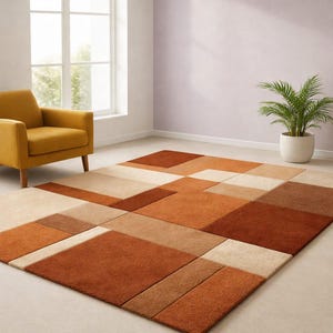 May include: A geometric patterned rug in shades of brown, beige, and orange. The rug has a modern design with rectangular and square shapes. The rug is placed on a light-coloured floor, with a yellow armchair and a potted plant in the background.