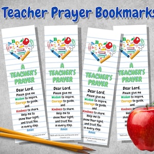 May include: Four white bookmarks with the text "Teacher Prayer" and a prayer. Each bookmark has a heart-shaped design with school supplies. Two pencils and a red apple are also in the image.