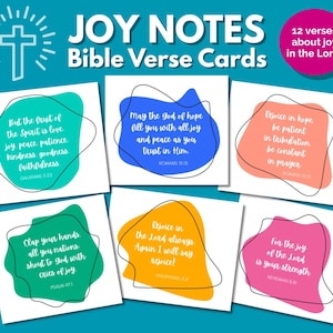 Może przedstawiać: Zestaw "JOY NOTES Bible Verse Cards" na turkusowym tle. Każda karta zawiera werset biblijny w różnych kolorach, takich jak niebieski, zielony, pomarańczowy i różowy, z czarnym obrysem. Karty mają nowoczesny, minimalistyczny design.
