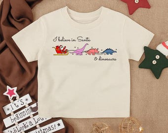I Believe in Santa und Dinosaurier Kleinkind Shirt, süßes Weihnachten Säugling T-Shirt, lustige Urlaub Kinder Outfit, Weihnachten Dinosaurier Jugend Top, festliches Baby Geschenk