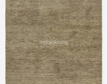 May include: A rectangular area rug featuring a solid, textured surface in shades of muted brown and taupe. The rug displays a horizontal, fibrous weave pattern throughout its entire expanse. The text Indianknots is printed in white in the center.