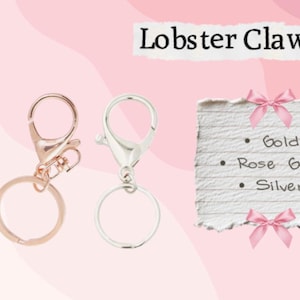 May include: Three lobster claw clasps in gold, rose gold, and silver, each with a key ring. The image includes a list on a torn paper with the text "Lobster Claw Clasp" and the colors "Gold", "Rose Gold", and "Silver".