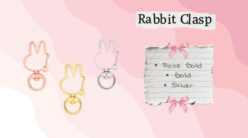 May include: Three metal rabbit-shaped clasps in rose gold, gold, and silver. The clasps have a swivel base and a ring for attaching to items. Text on a paper reads "Rabbit Clasp" and lists color options: Rose Gold, Gold, and Silver.