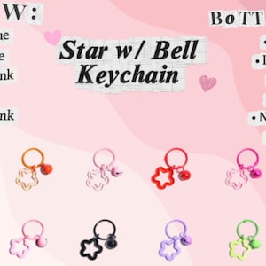 May include: A collection of star-shaped keychains with bells in various colors, including clear sky blue, orange, light pink, red, neon pink, sky blue, orange, light pink, black, purple, neon green, and yellow. The text "Star w/ Bell Keychain" is displayed.